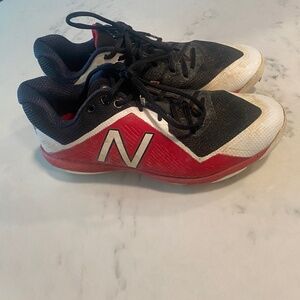 red and black new balance baseball cleats (metal spikes)